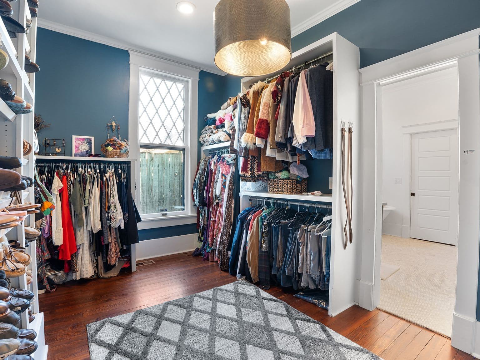Dream walk-in closet with built-ins and designer lighting.