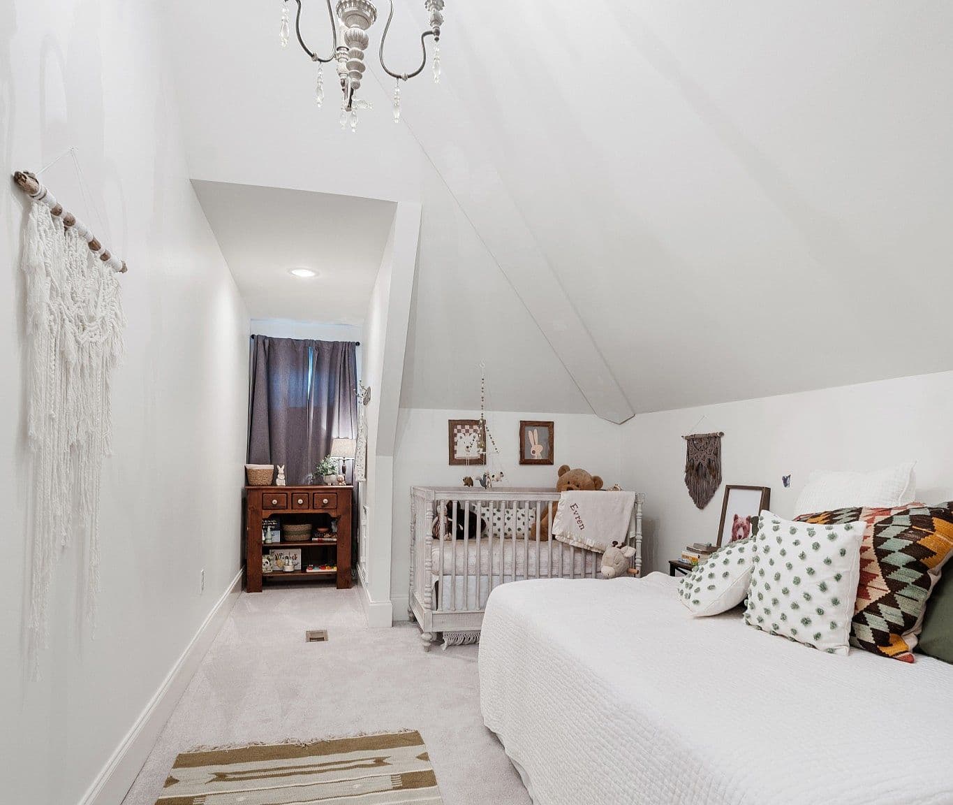 Cozy nursery nook with vaulted ceiling and soft light.