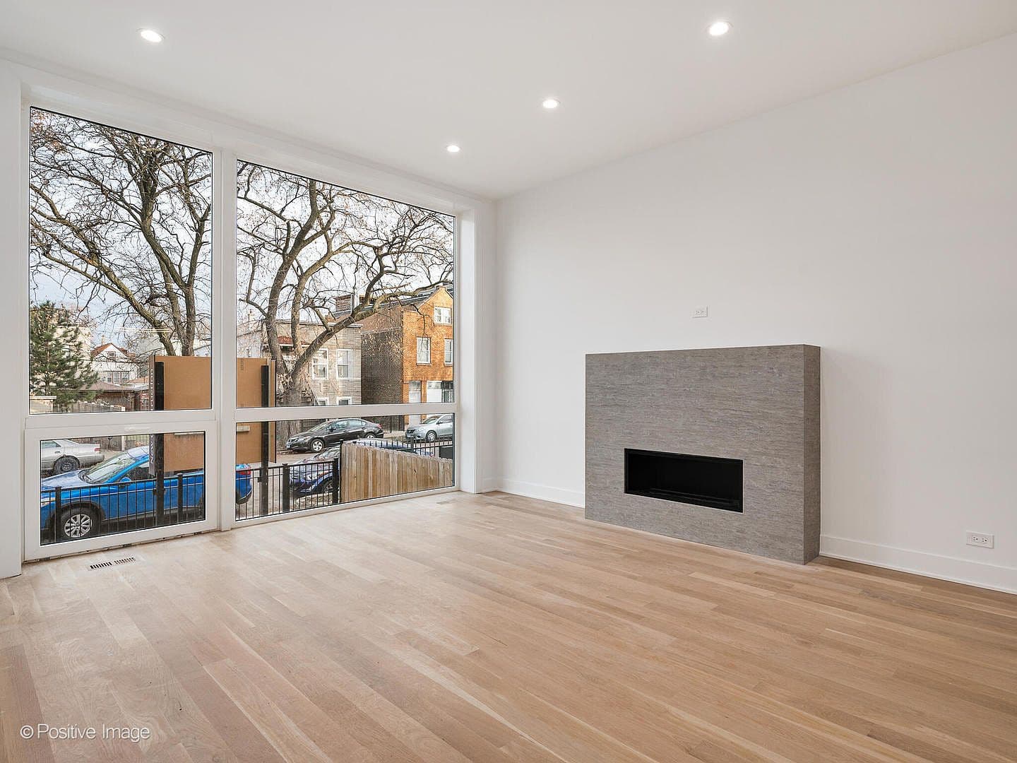 Bright living room anchored by sleek linear gas fireplace