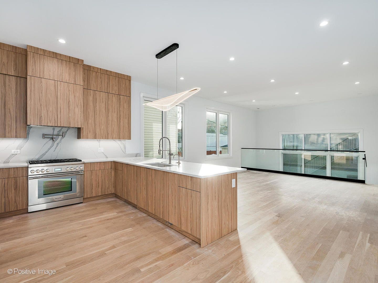 Chef's kitchen with Thermador range and glass-rail overlook
