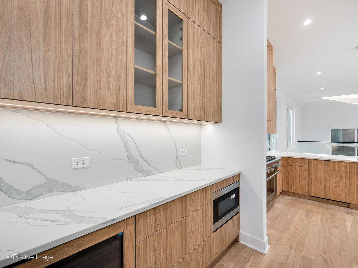 Butler's pantry with quartz counters and beverage center