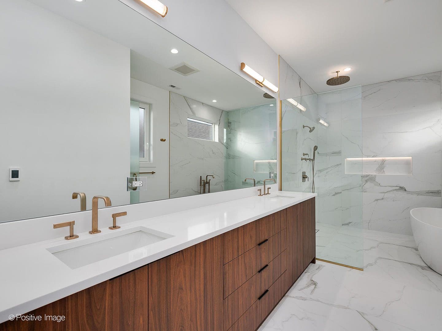 Spa-like primary bath with double vanity and rain shower