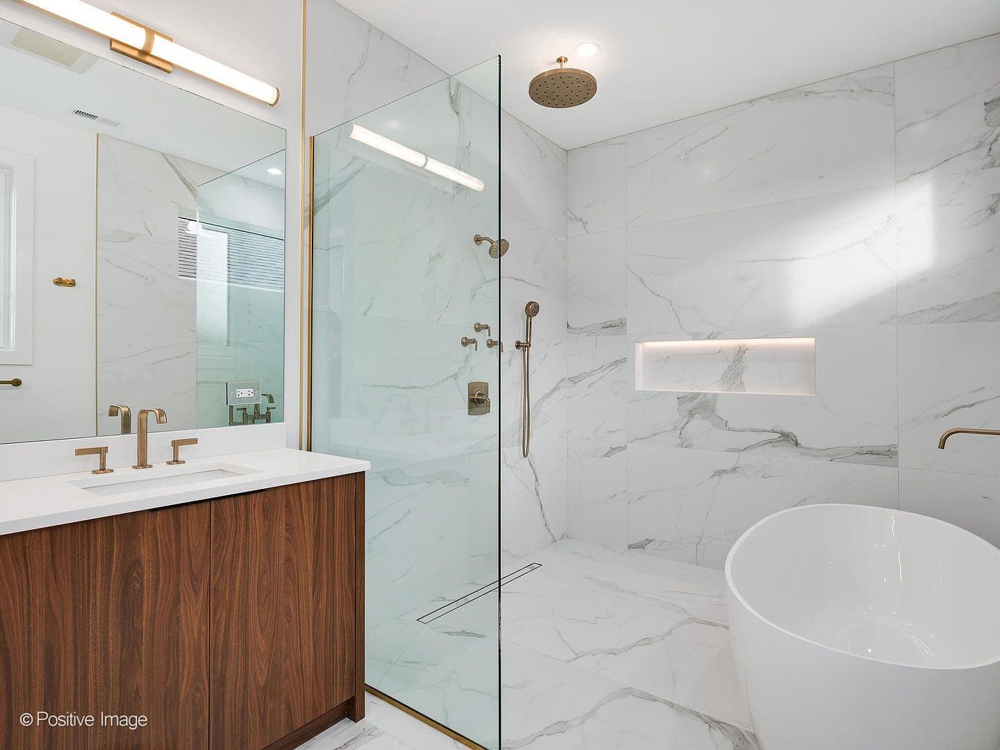 Primary bath with freestanding tub and brass fixtures