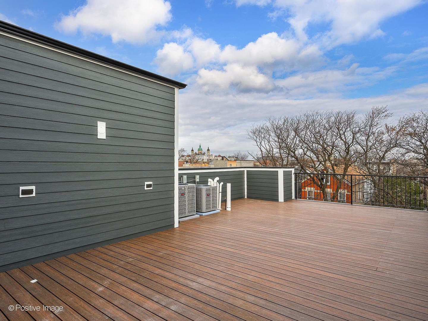 Expansive composite roof deck with wrought-iron rail