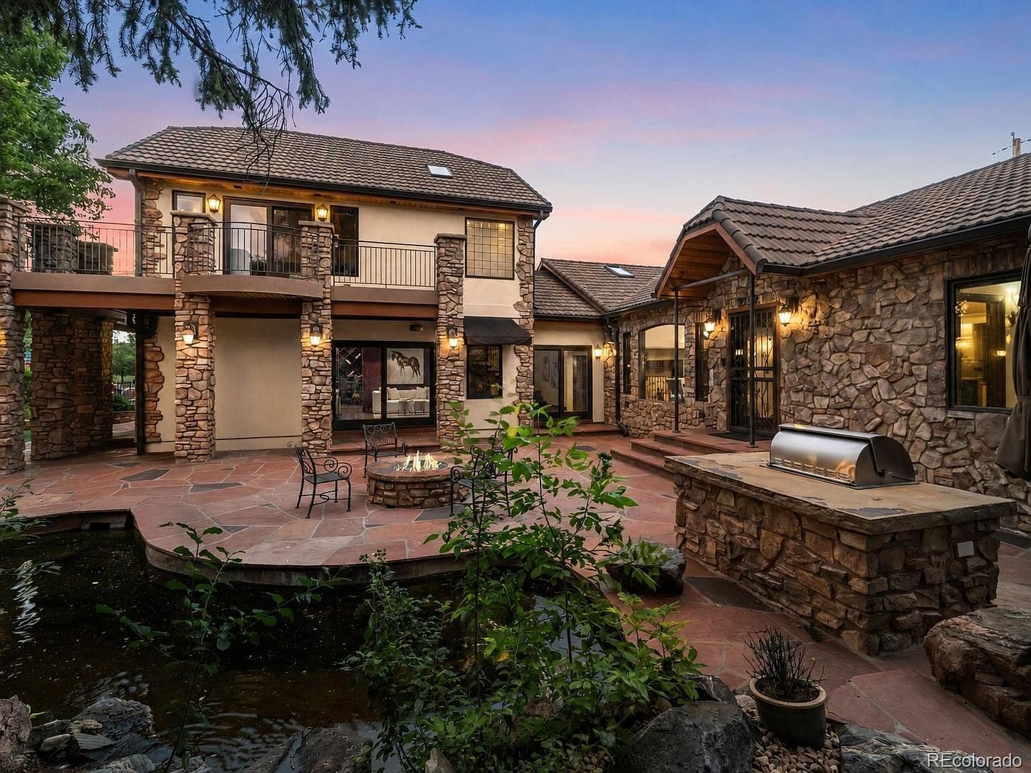 Entertain beside the koi pond, fire pit, and grilling island.
