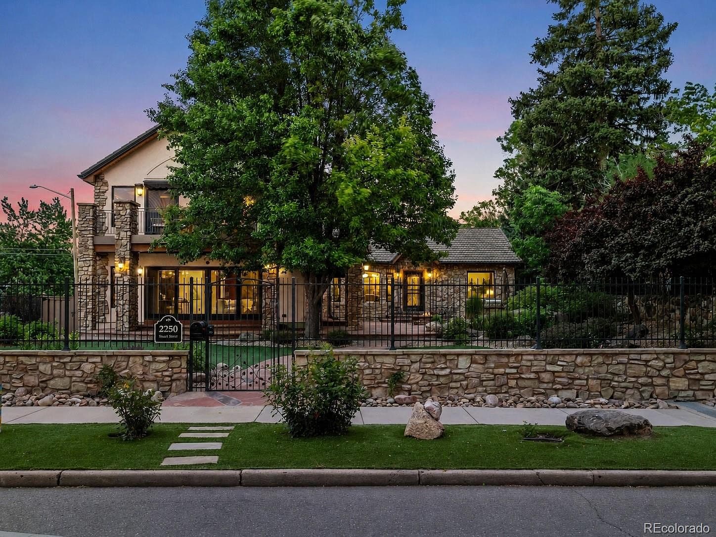 A gated entrance welcomes you to this stone-accented home.
