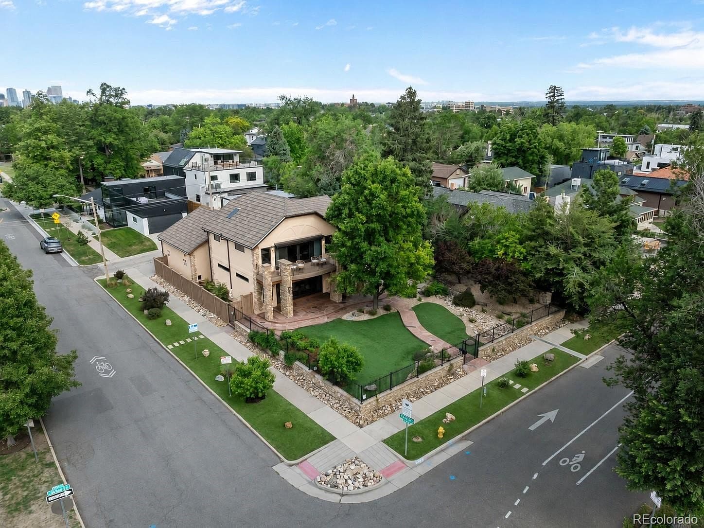 Aerial view highlights the landscaped corner property and balcony.