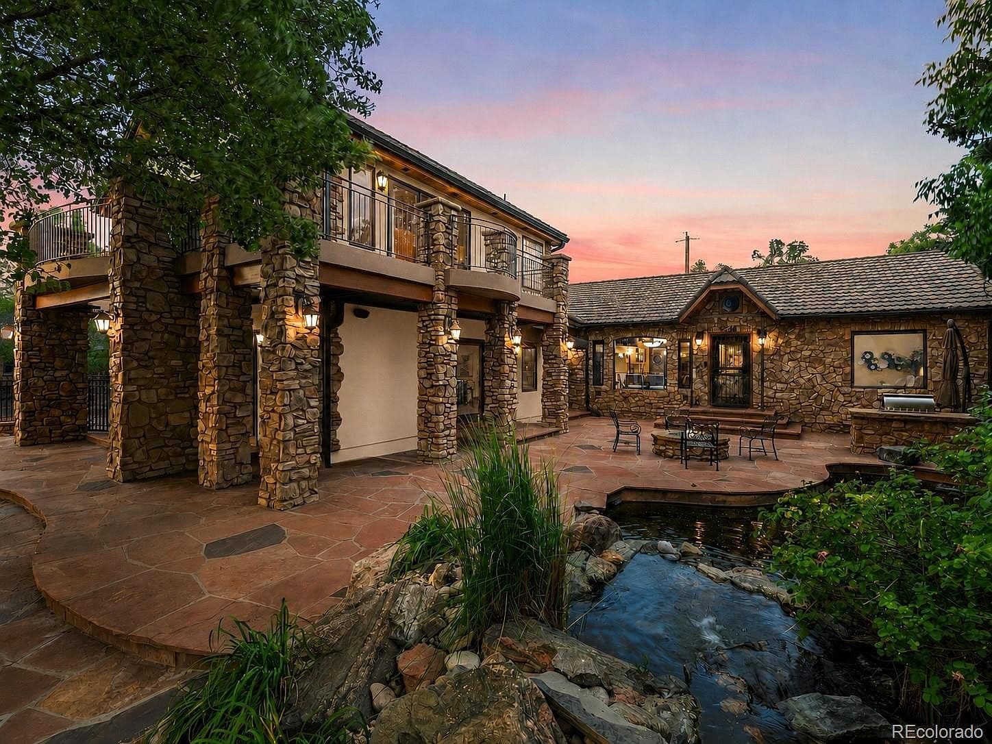 A cascading waterfall adds tranquility beside the flagstone patio.