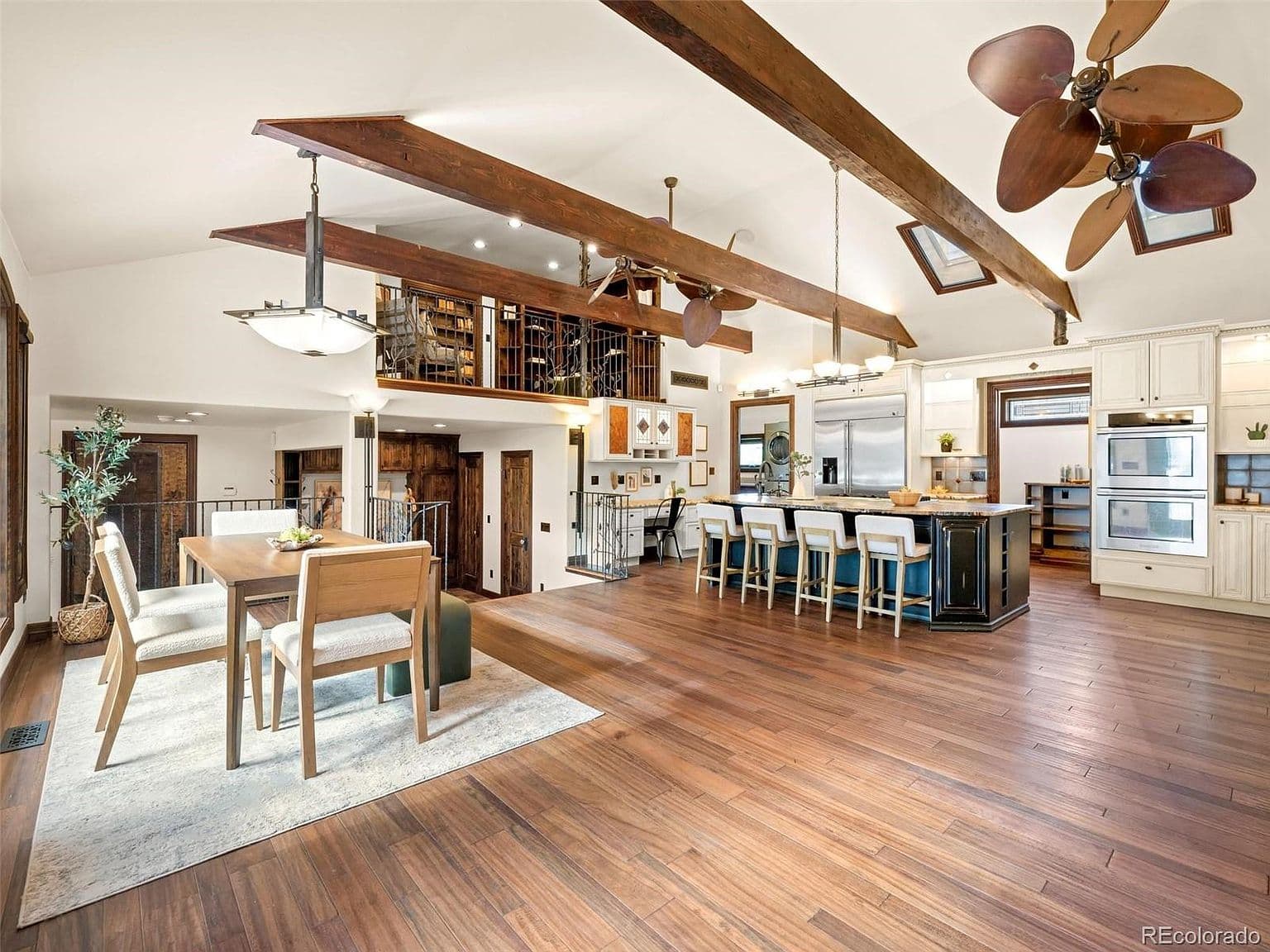 Vaulted ceilings and exposed beams crown the island kitchen.