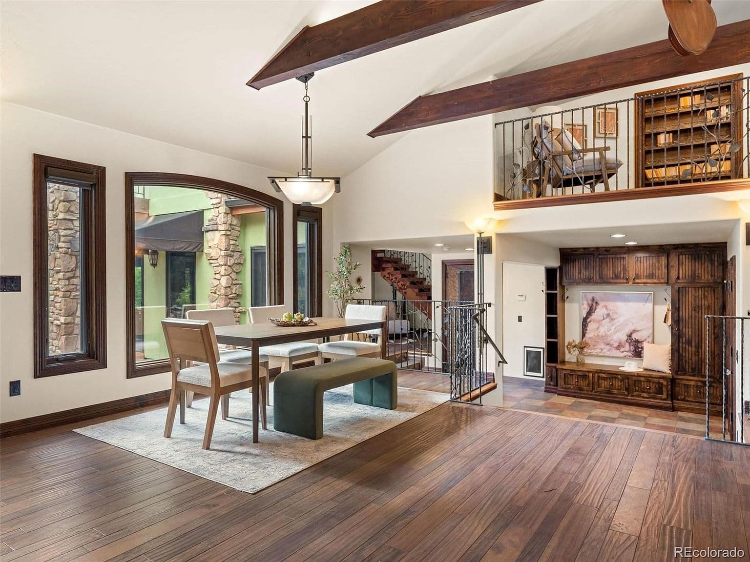 A bright dining area overlooks the stone-accented courtyard.