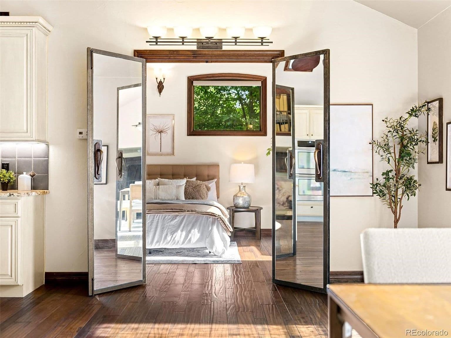 Glass doors open to the inviting main-level primary suite