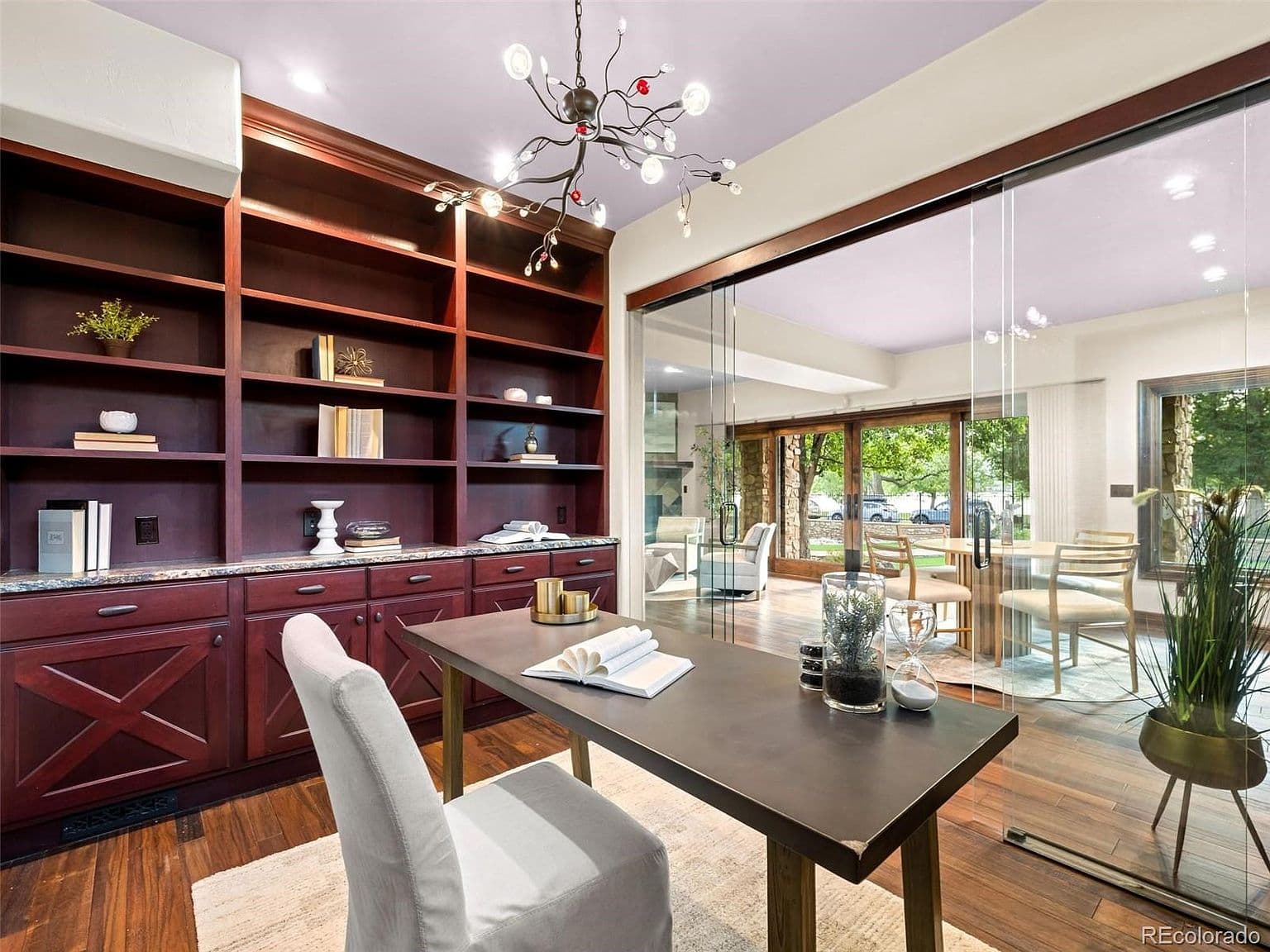 Glass-walled study offers built-ins and views toward the lake