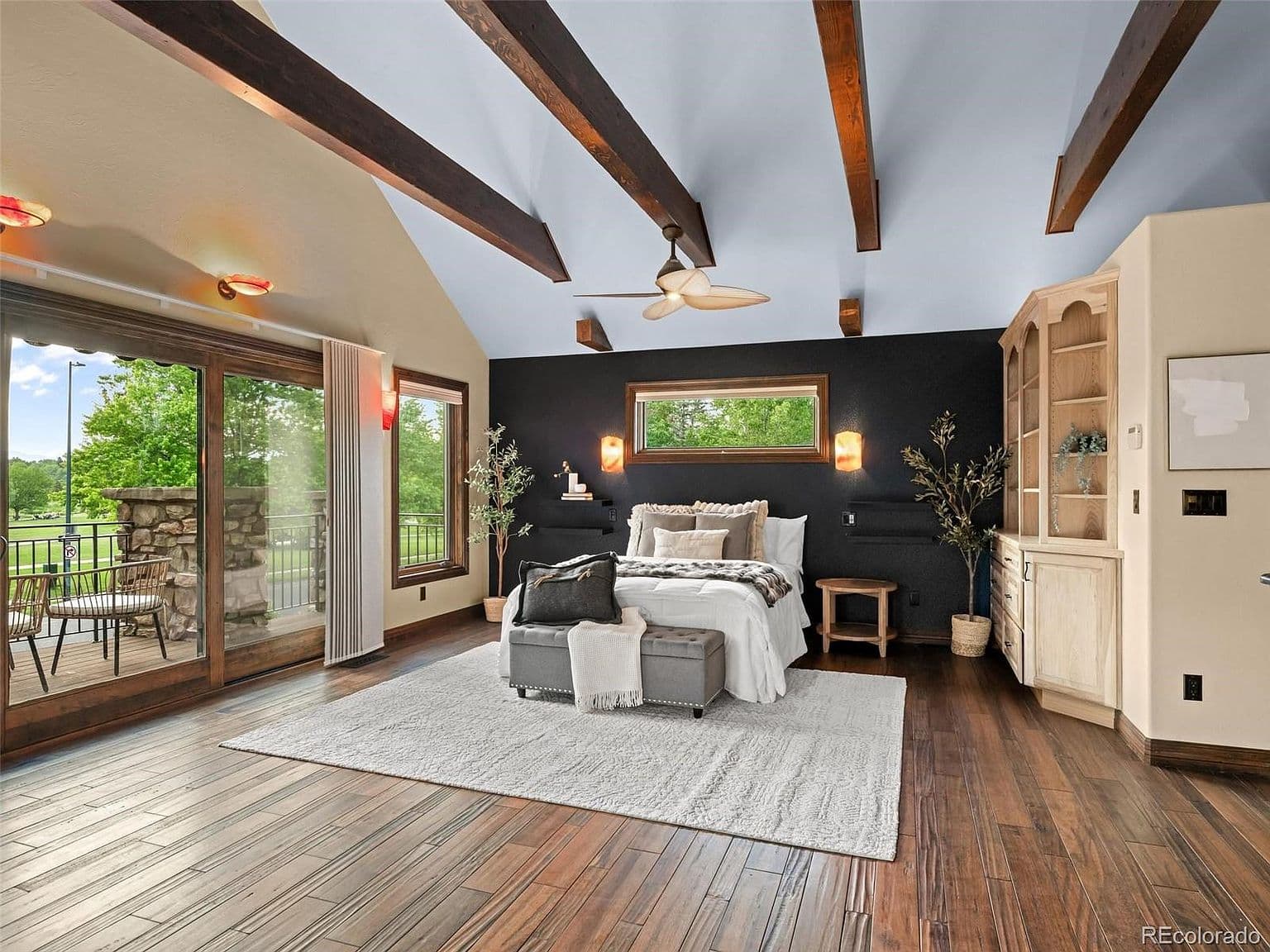 Vaulted upstairs suite opens to a private balcony.