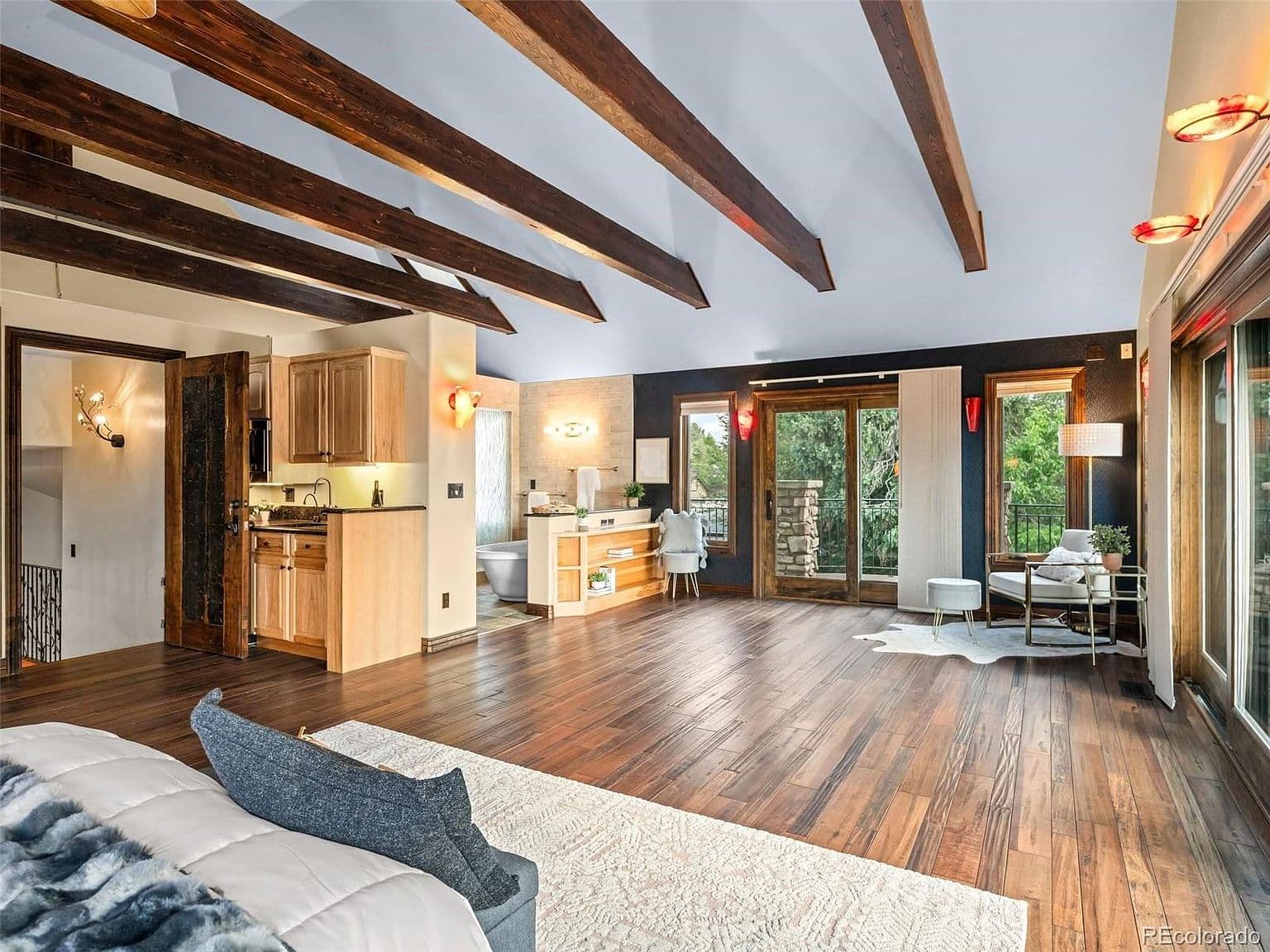 Spacious owner’s suite connects to its balcony and bath.