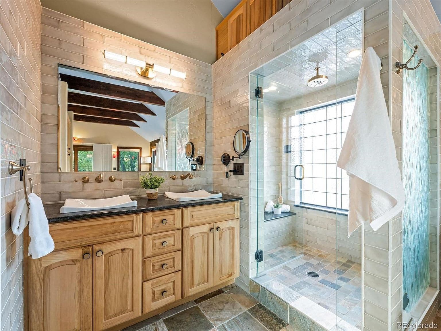 Double vanity and glass shower brighten the owner’s bath.