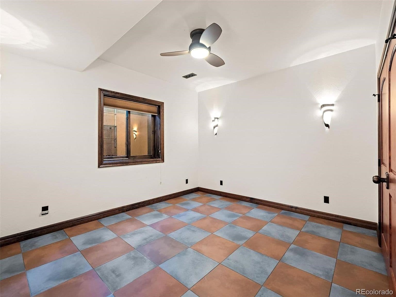 Flexible room with colorful tile and warm wood trim