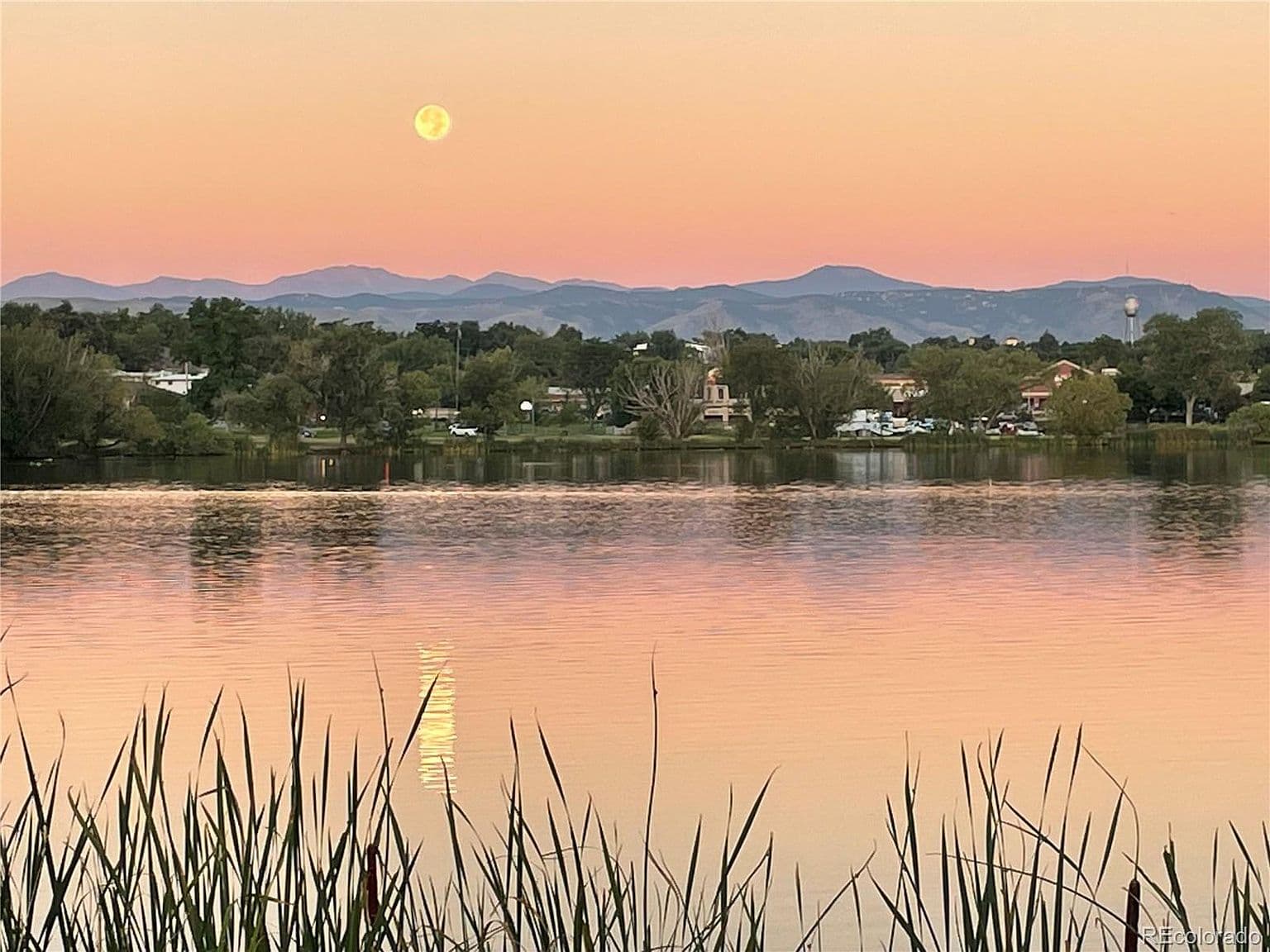 Moonlight shimmers across the lake beneath mountain silhouettes