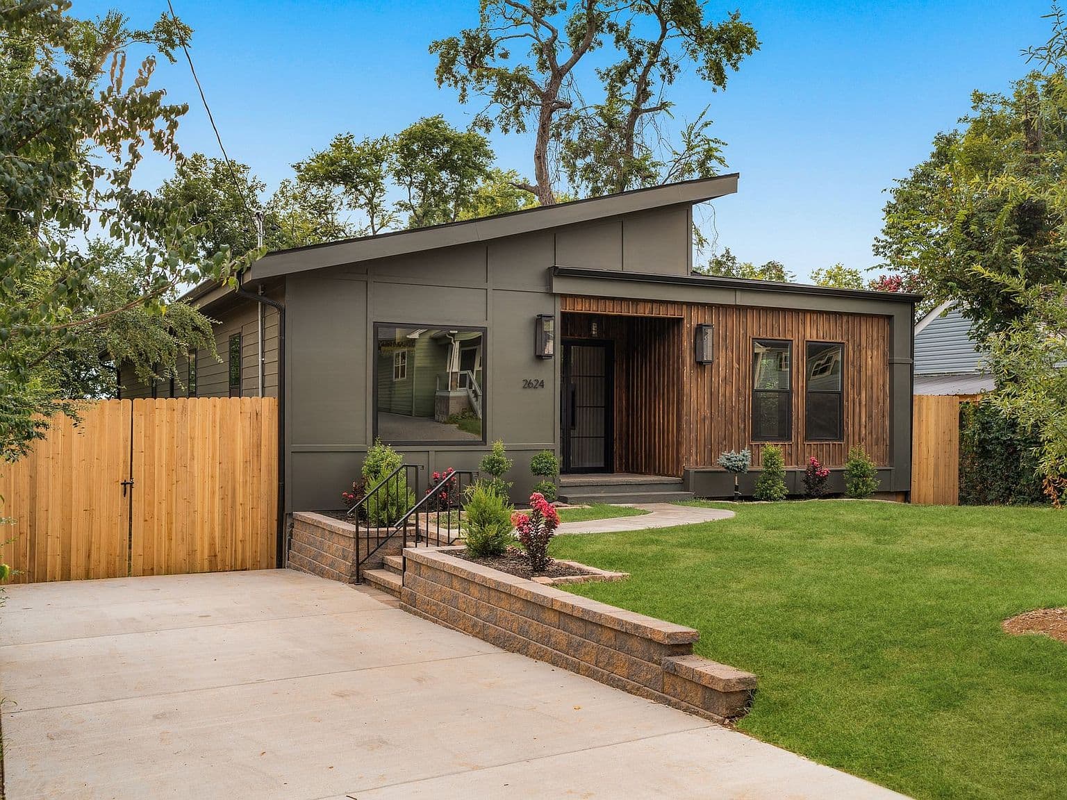 Wide drive and landscaped approach to modern Nashville retreat.