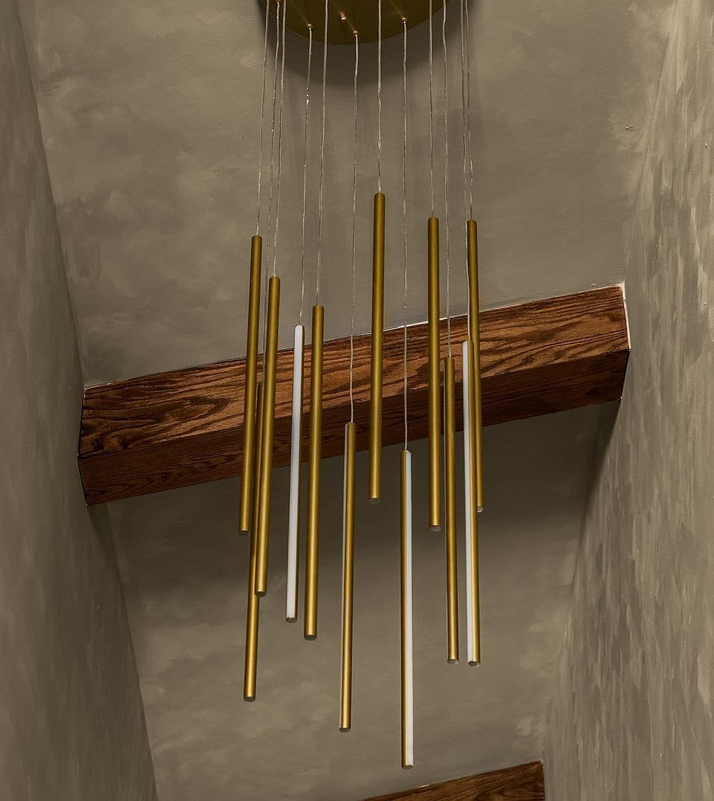 Modern pendant lighting highlights the home’s vaulted ceiling.