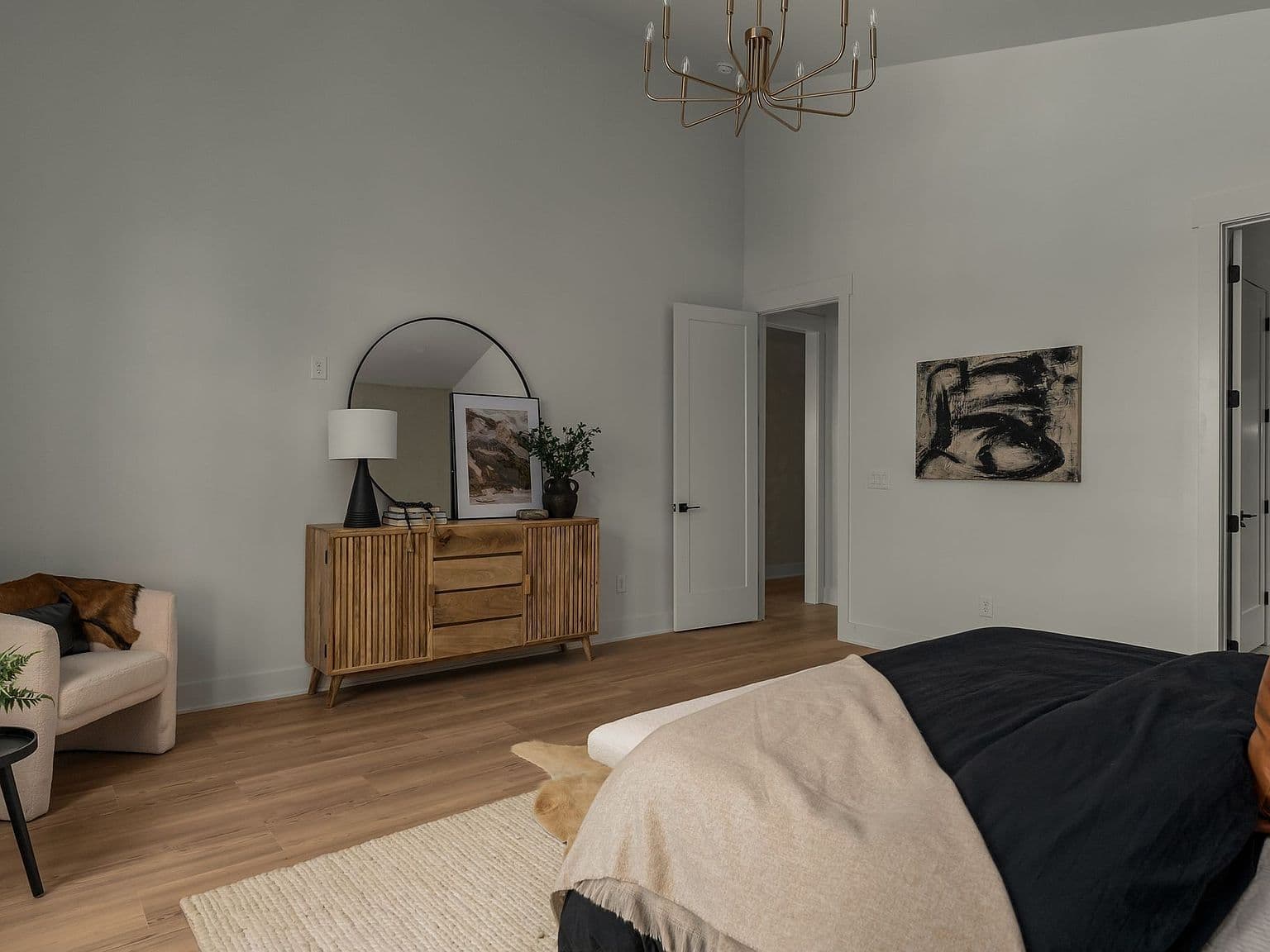 Spacious vaulted suite with arched mirror and rich hardwoods.