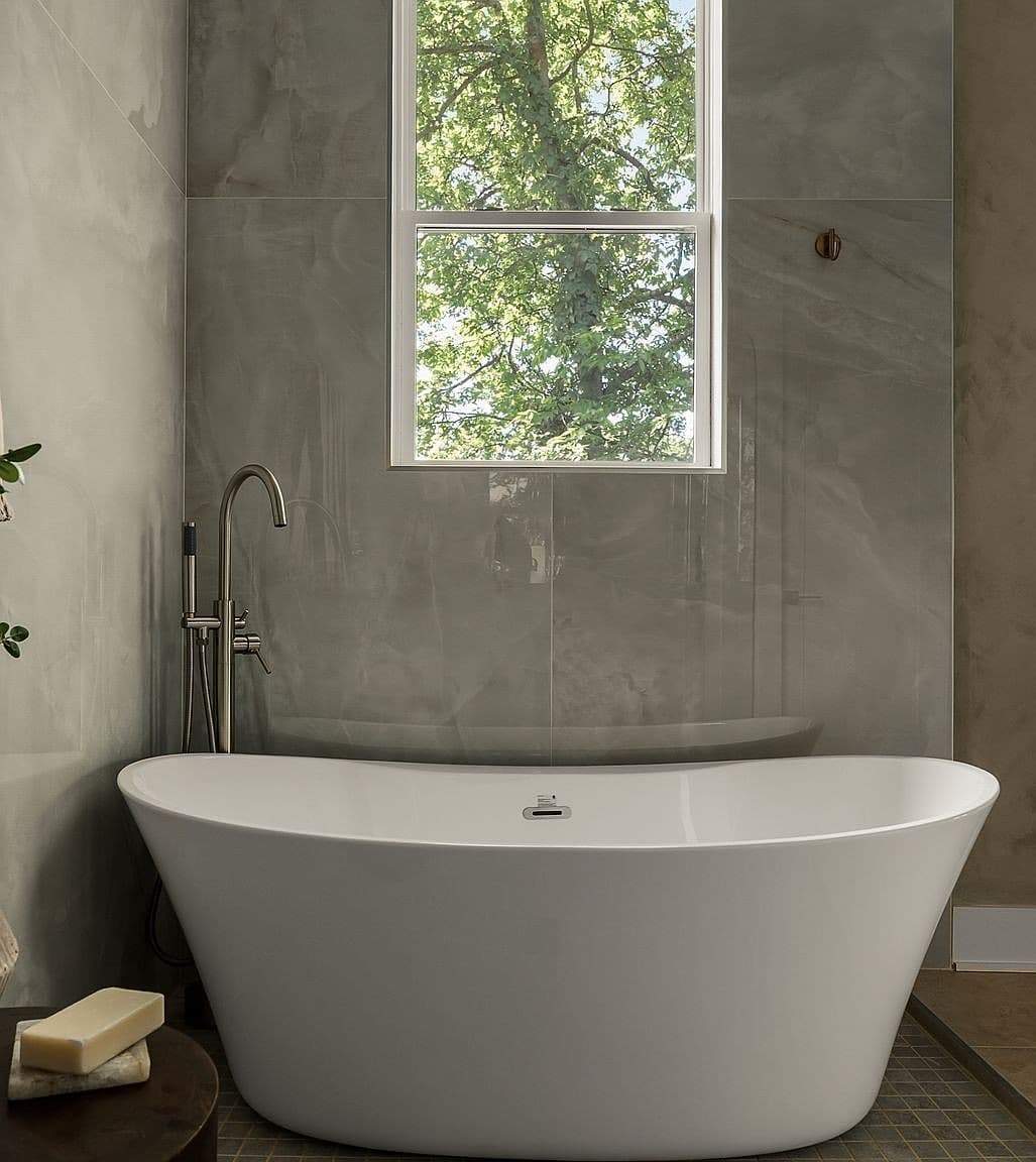 Soaking tub framed by serene window and natural light.