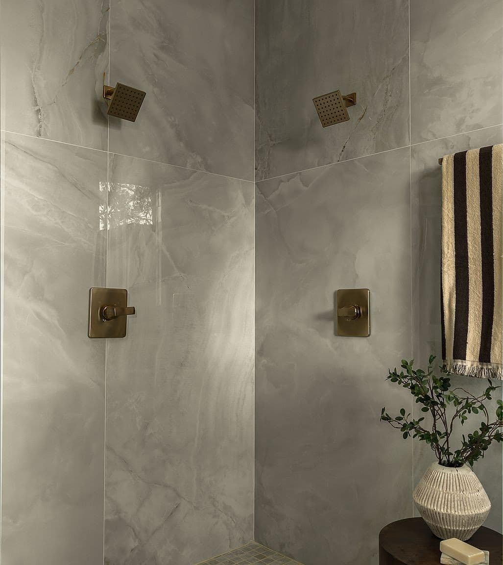 Luxury double-head shower with custom hand-laid tile.