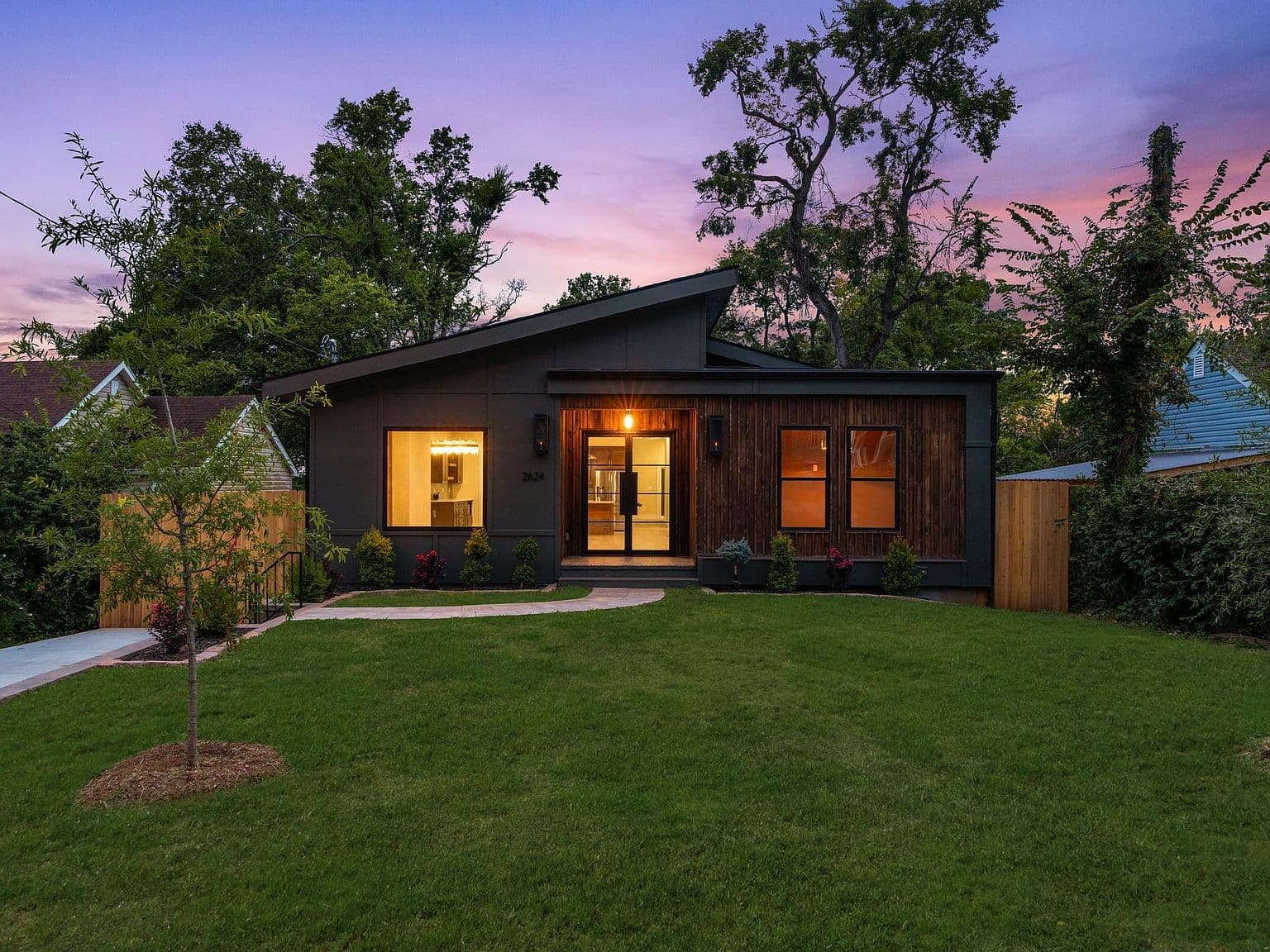 Twilight curb appeal on a private, wooded Nashville lot.