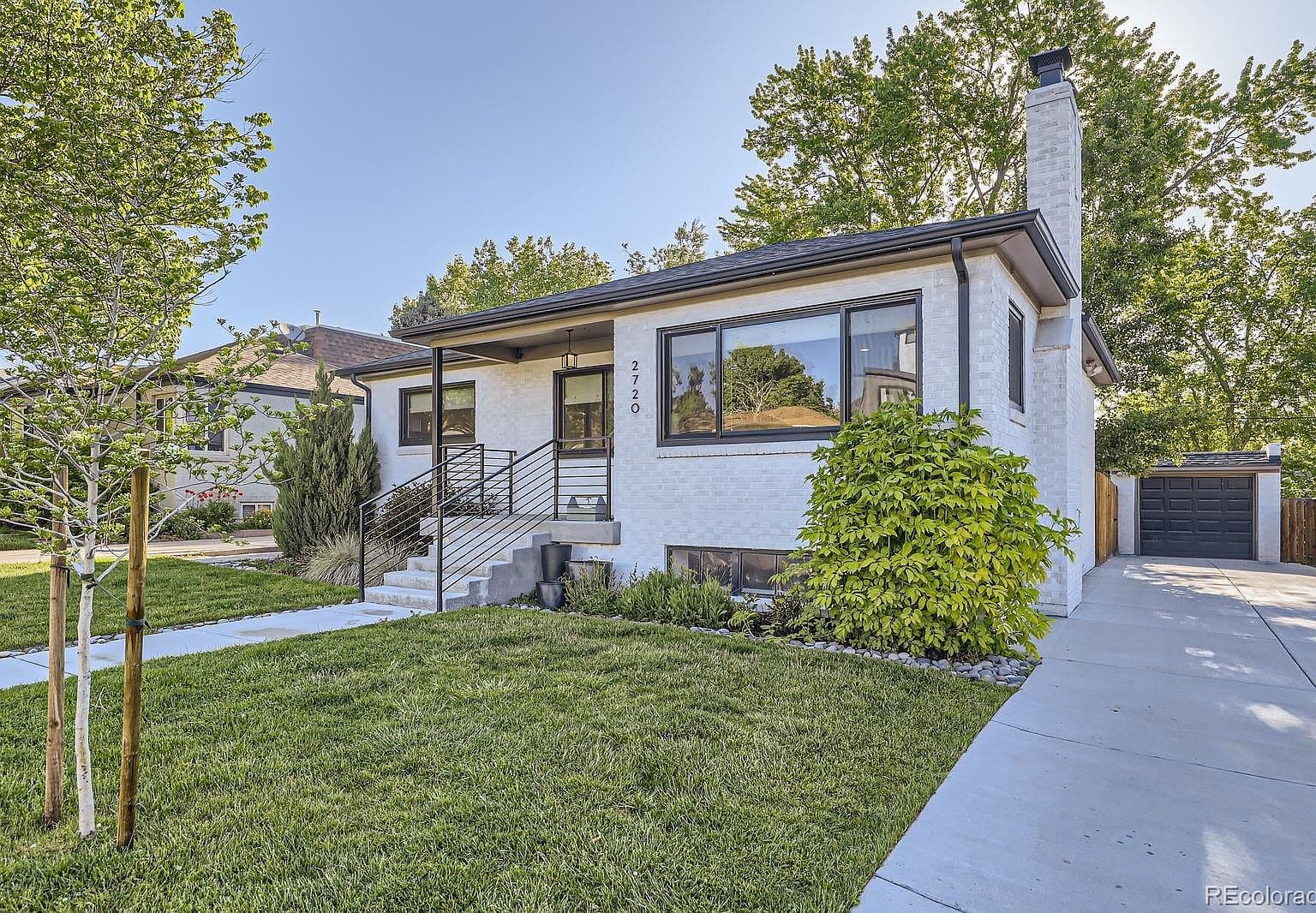 Fresh curb appeal with a driveway and detached garage