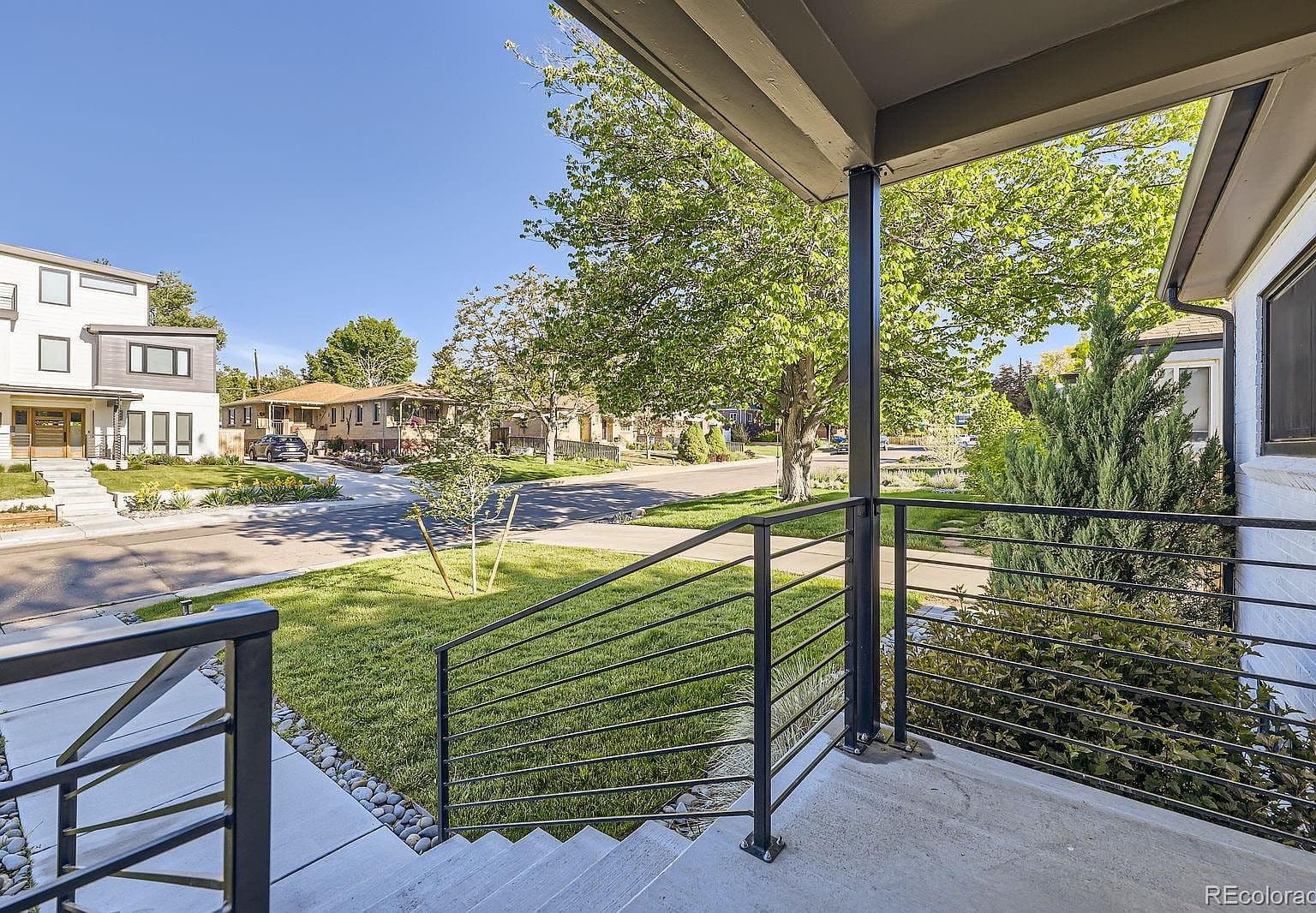 Front porch overlooks the leafy, tree-lined street