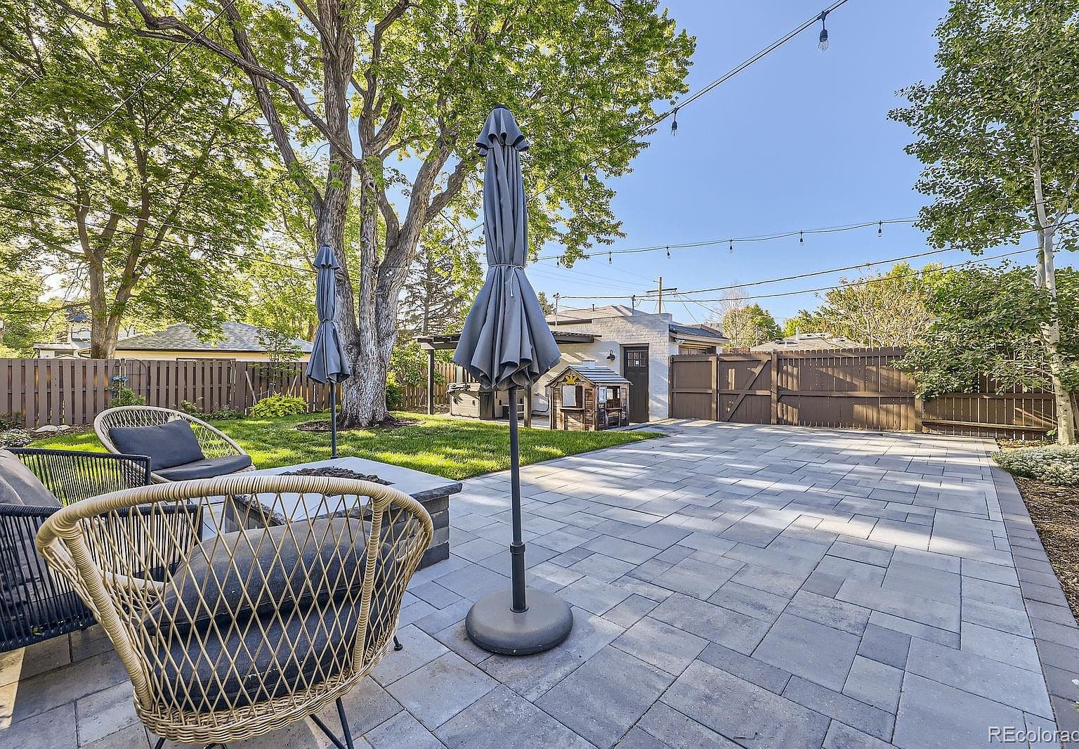 Expansive paver patio sets the stage for outdoor gatherings