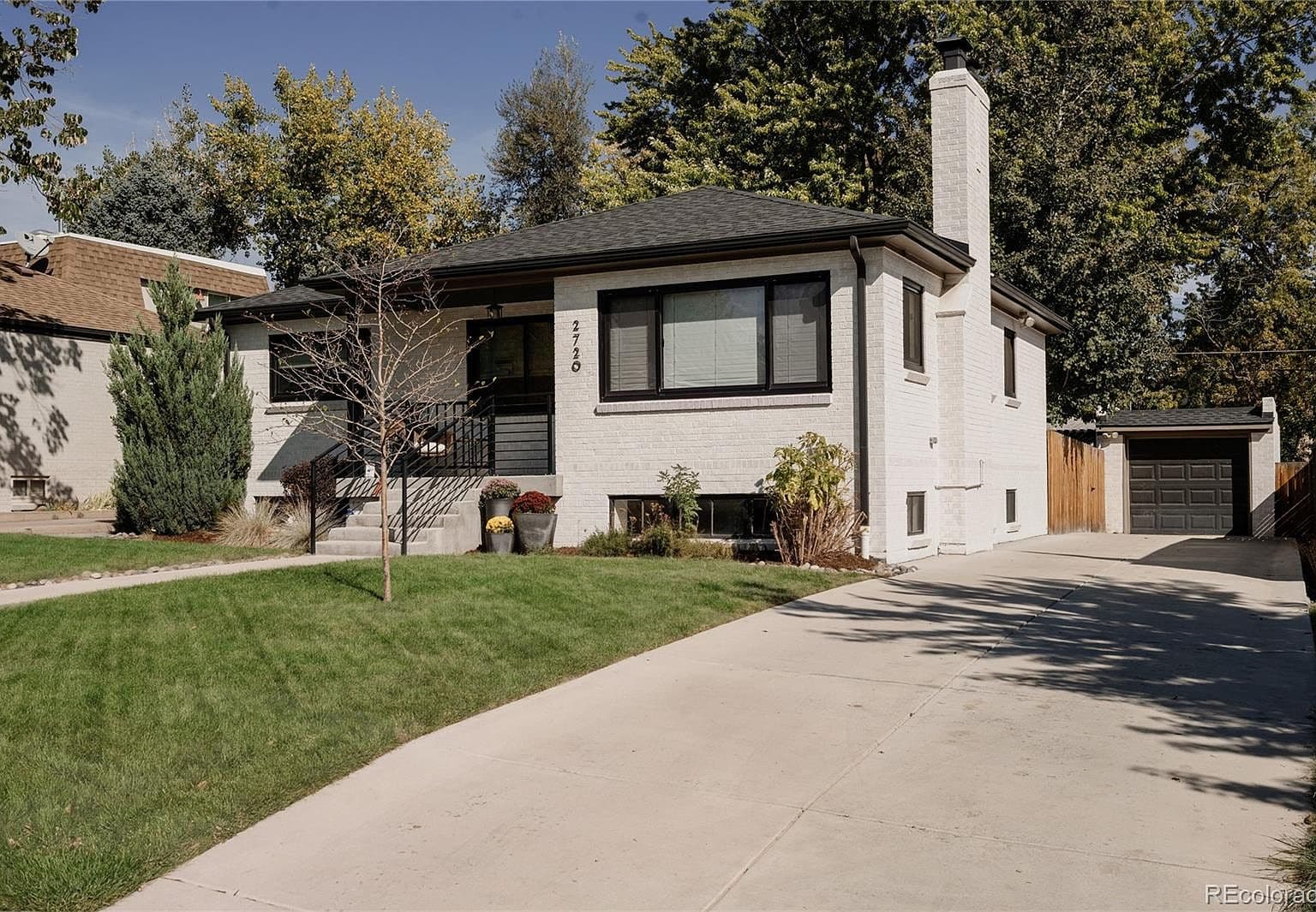 Long driveway leads to the one-car detached garage