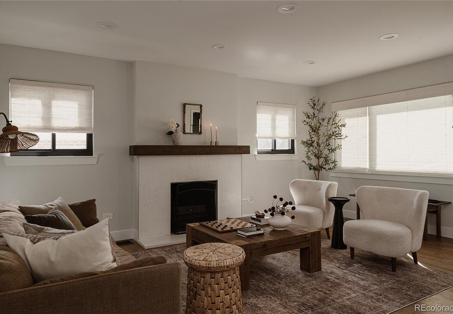 Sunlit living room offers cozy seating around the fireplace