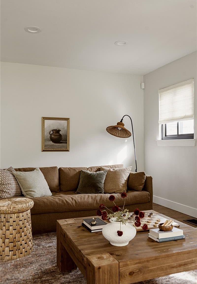 Sunlit living room pairs plush seating with natural textures.