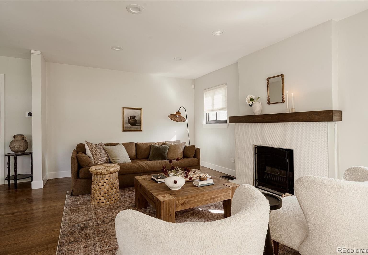 Inviting living room centers on a beautifully tiled fireplace.