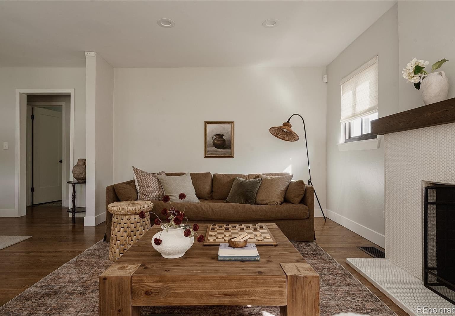 Relaxed living space features hardwood floors and cozy seating.