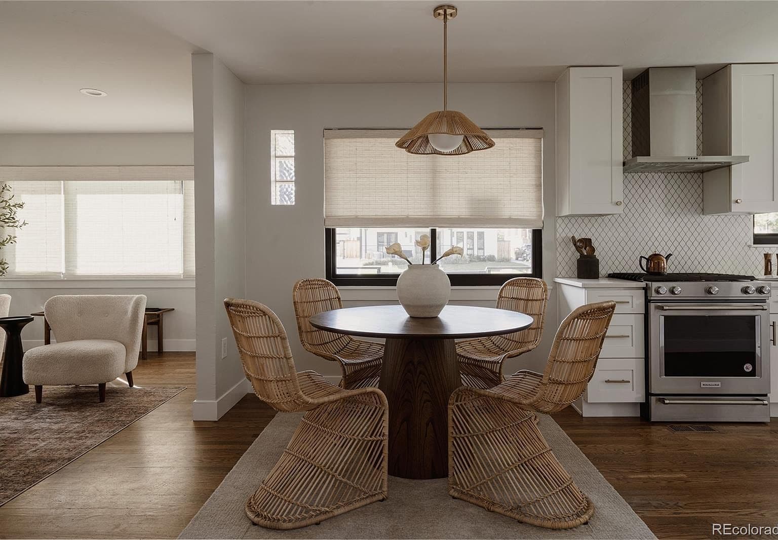 Round dining table sits beside the sleek kitchen range.