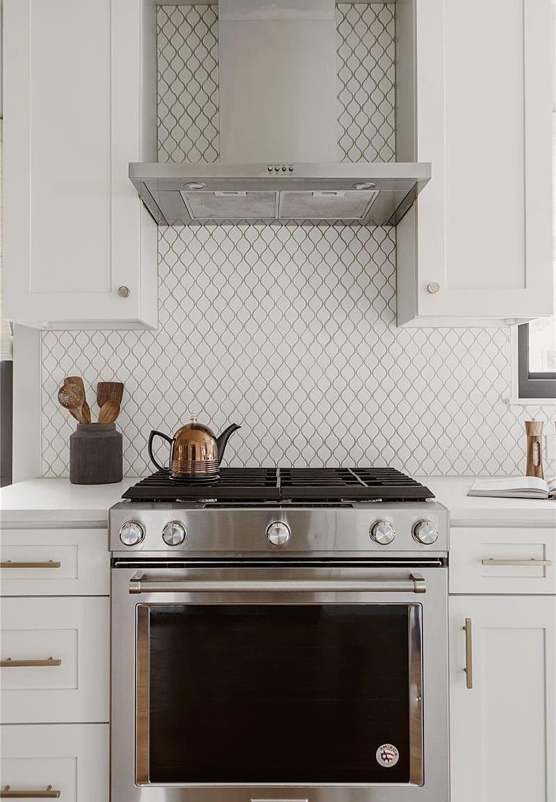 Statement range hood crowns the stainless steel gas stove.
