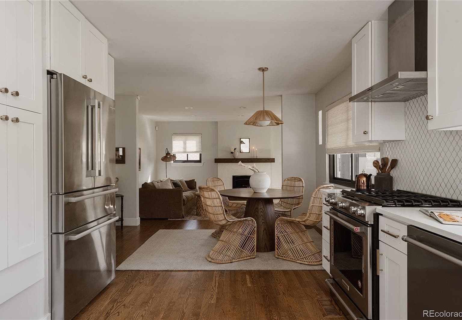 Open kitchen and dining area flow toward fireside living.