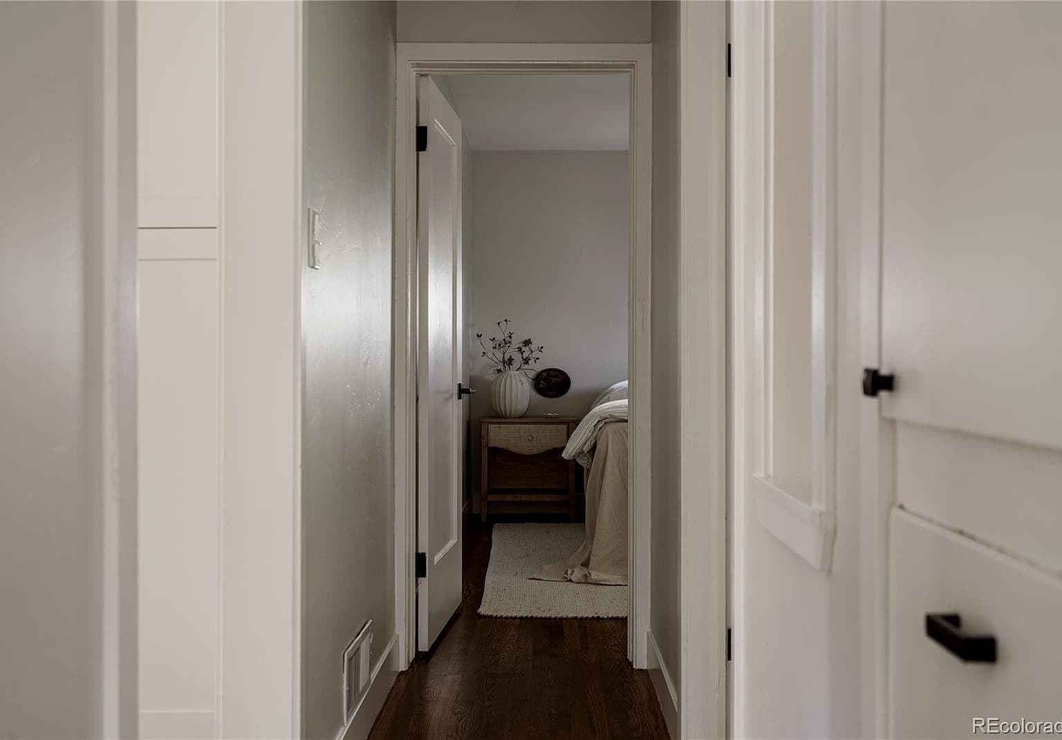 Wood-floored hallway leads to a restful bedroom retreat.