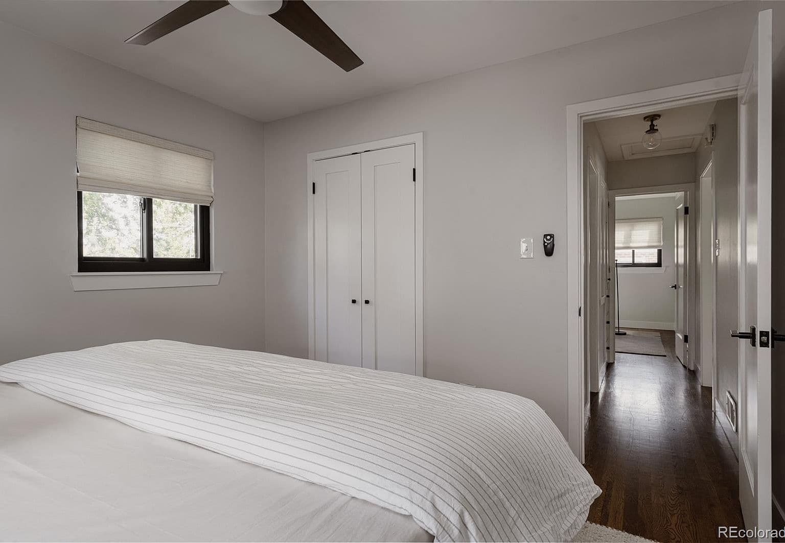 Bedroom offers a closet and warm wood flooring.