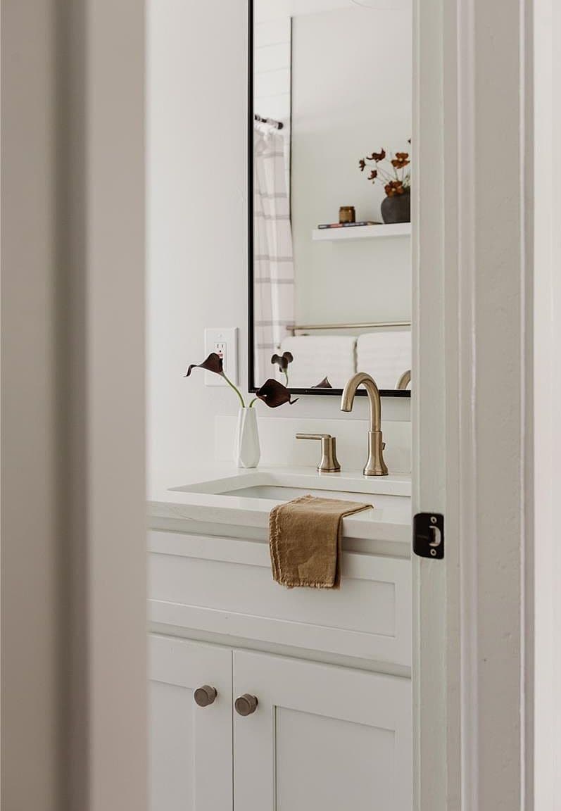 Fresh white bathroom vanity features a sleek inset sink.