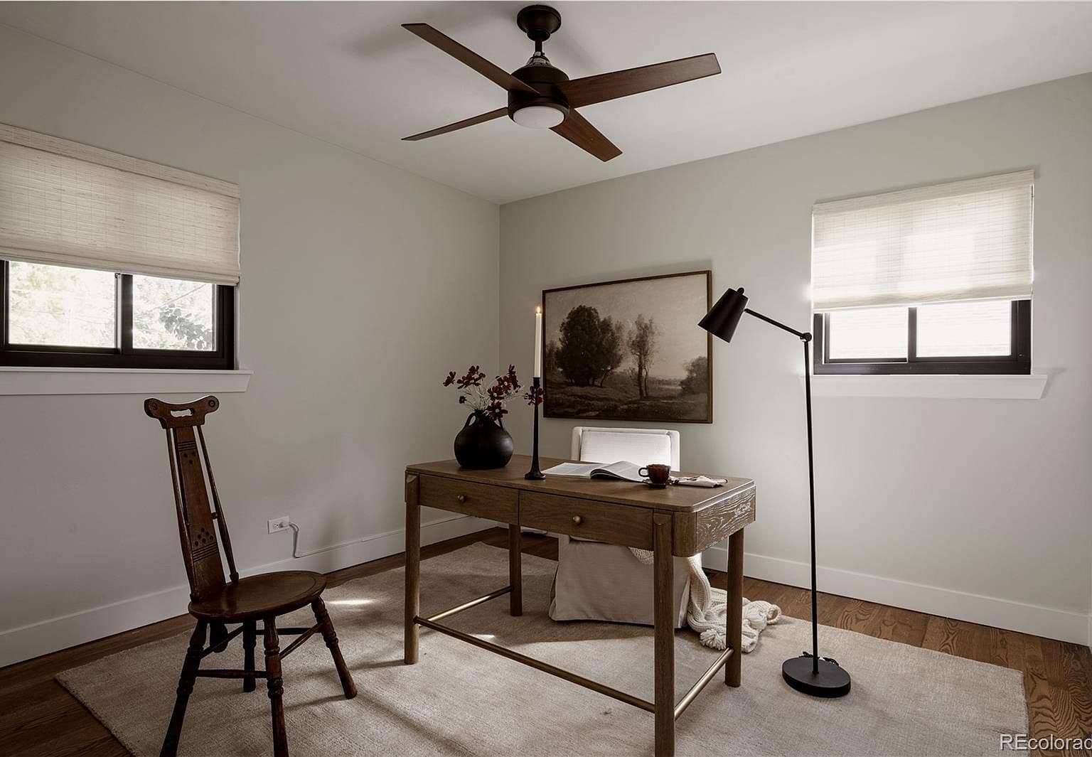 Two windows brighten this versatile home office.