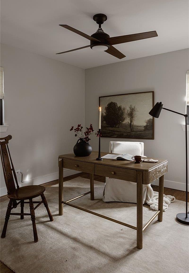 Wood floors and a ceiling fan complete the flexible office.