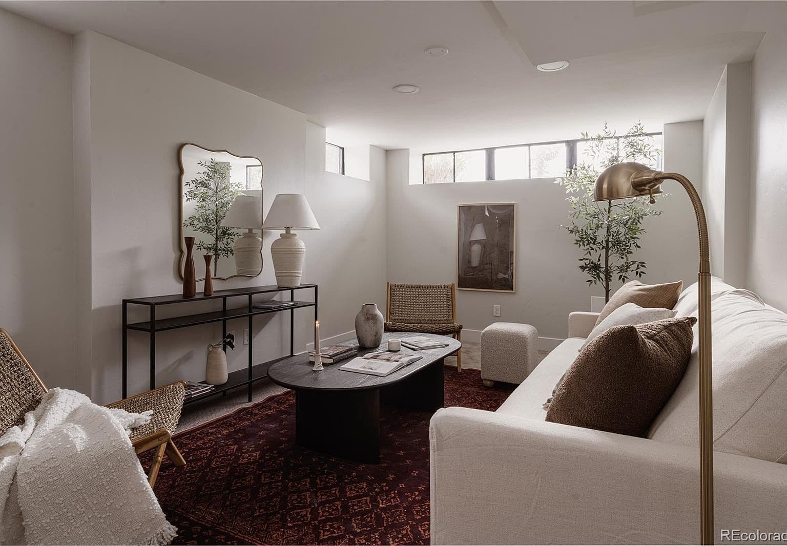 Finished basement lounge offers comfortable space to unwind.