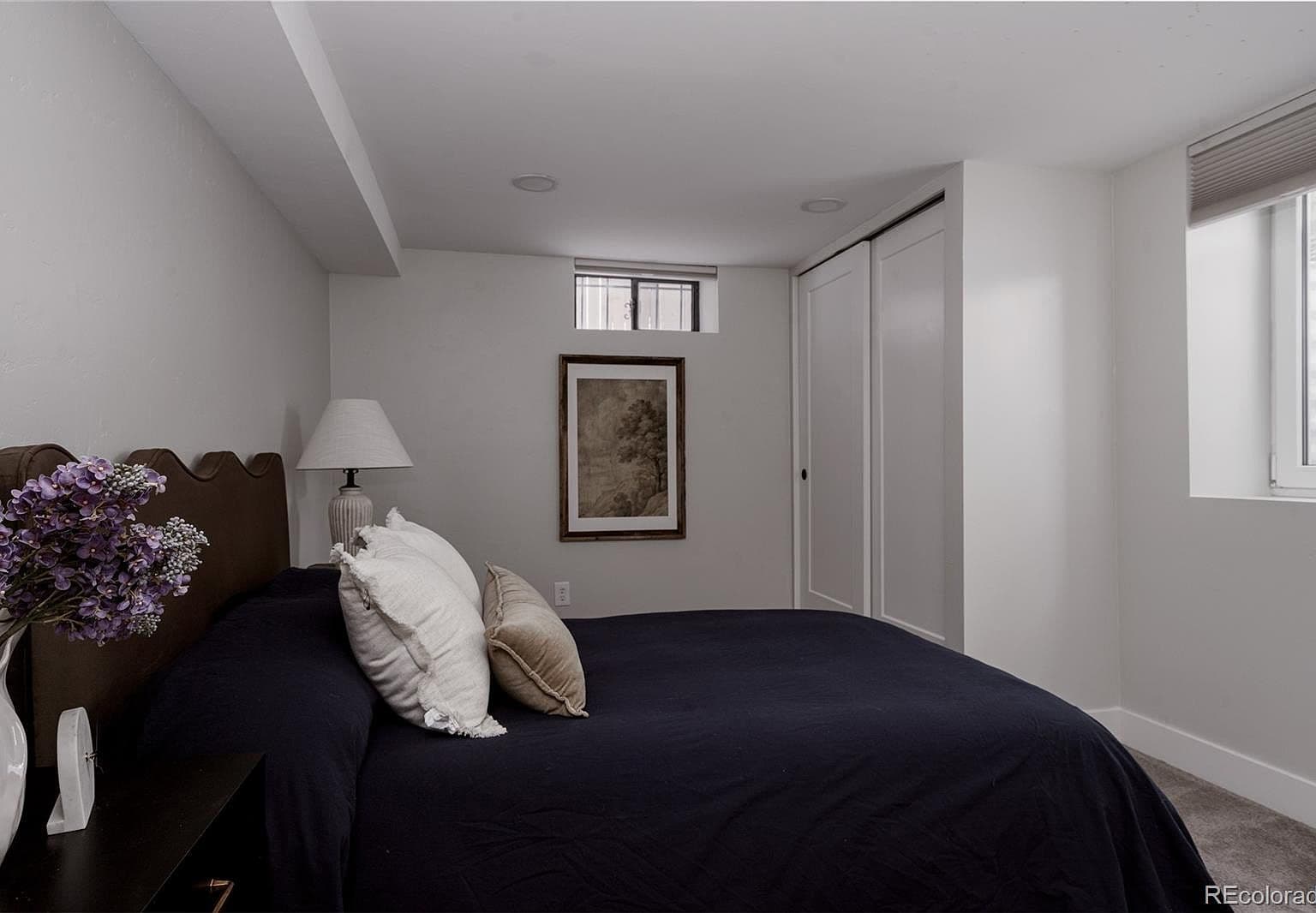 Basement bedroom features two windows and a spacious closet.