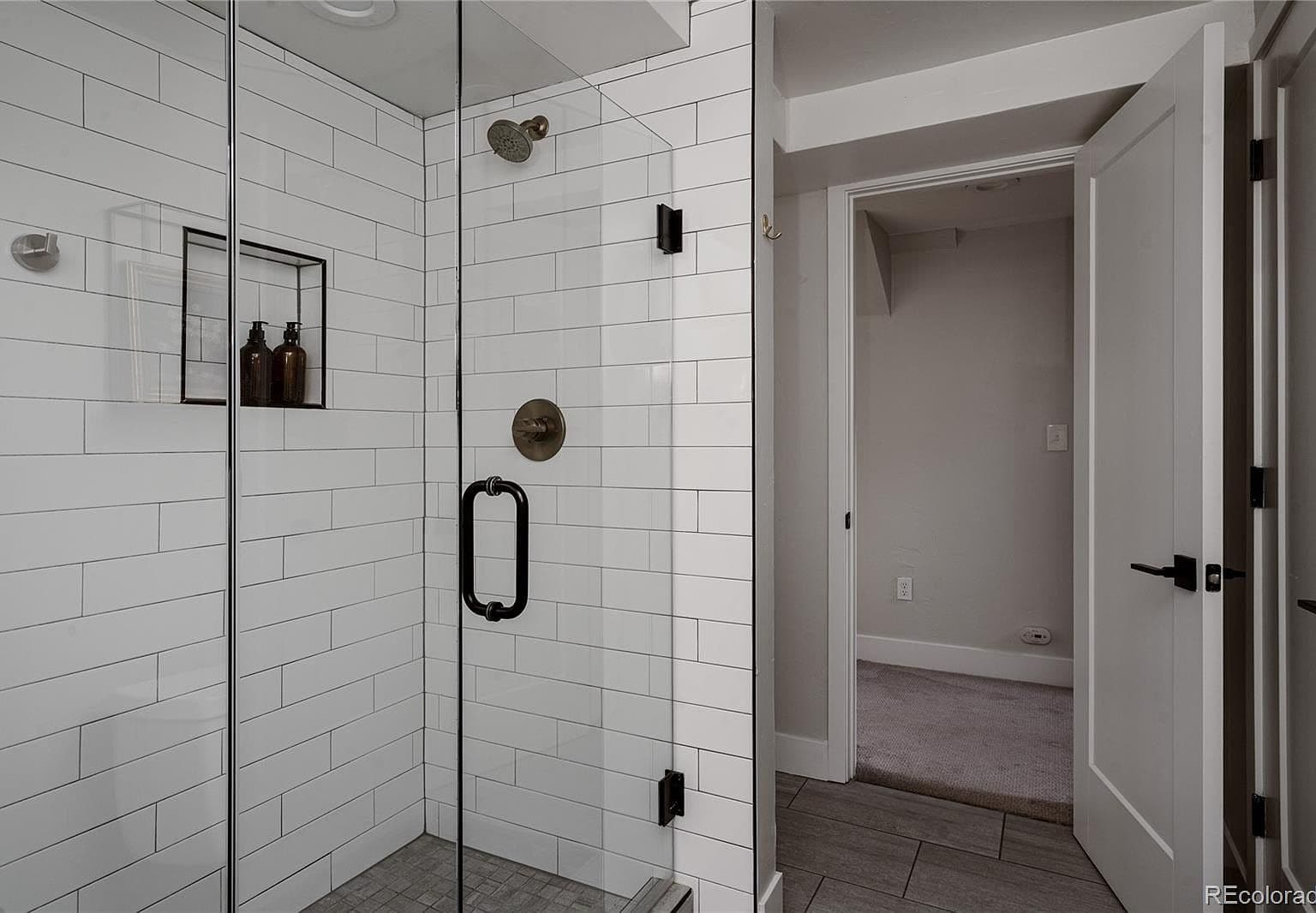 White subway tile brightens the glass-enclosed shower.