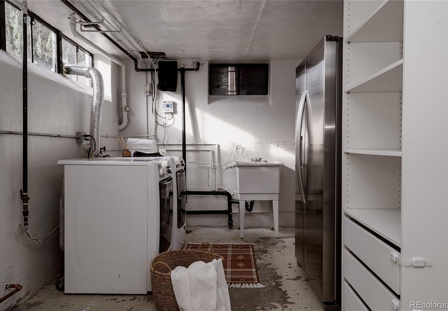 Laundry space offers open shelving for convenient storage.