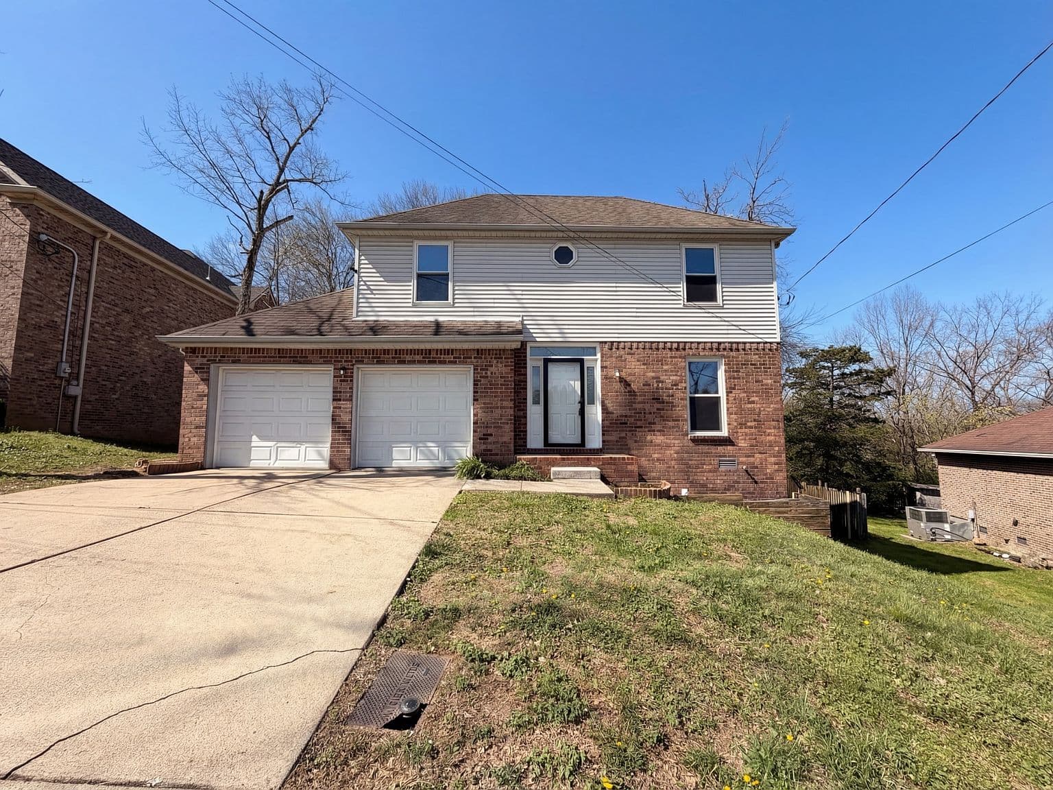Brick-front home with attached two-car garage.