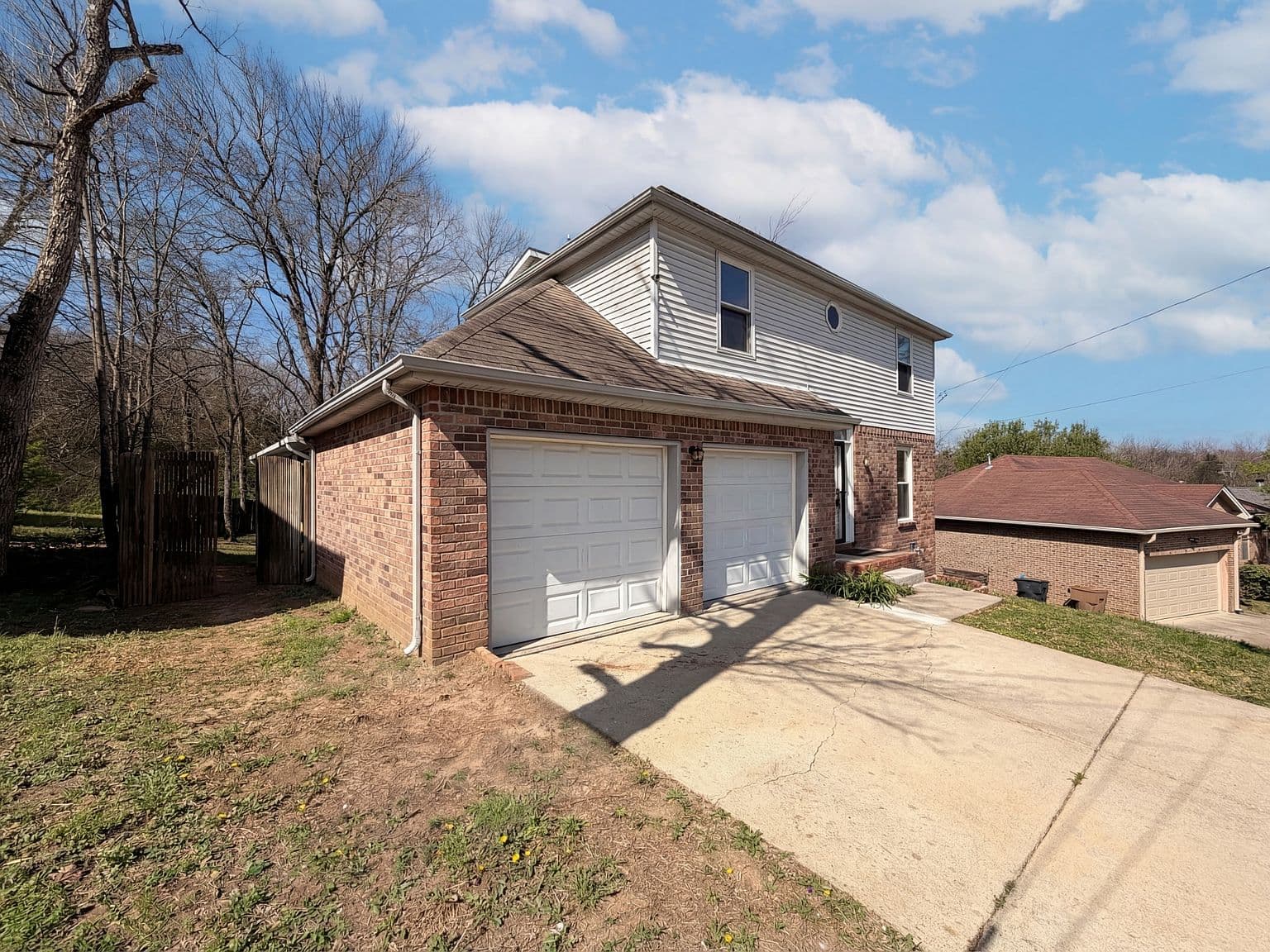 Spacious driveway and side access to fenced yard.