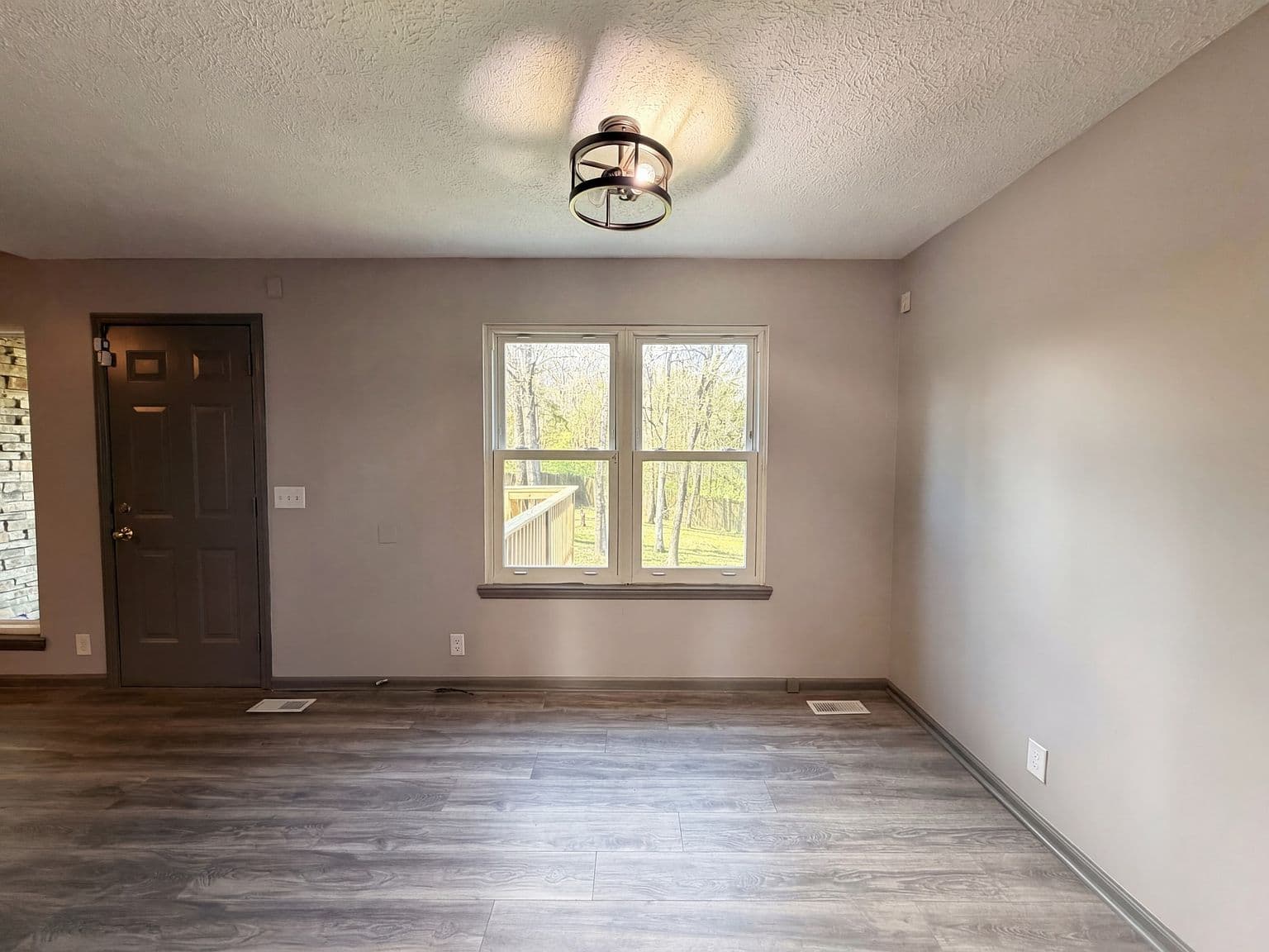 Flexible living space with natural light and backyard views.